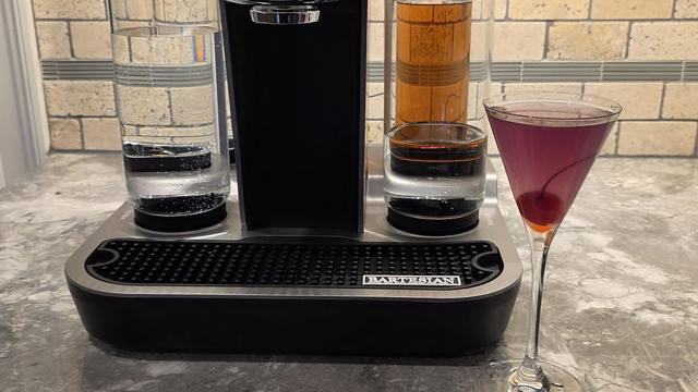 Bartesian Aviation pod cocktail in tall stemmed glass with maraschino cherry