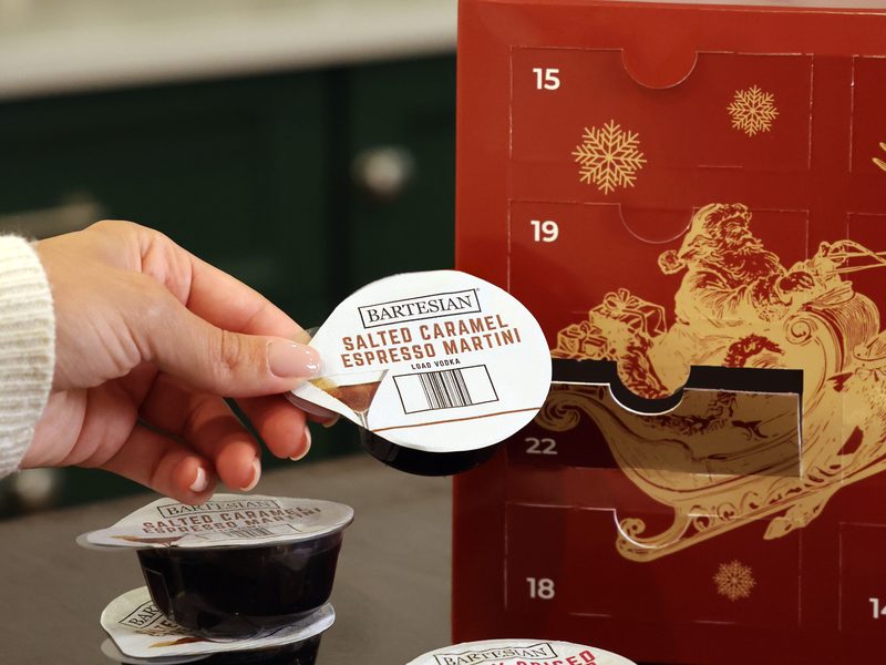 A Salted Caramel Espresso Martini capsule held beside the open Advent Calendar box