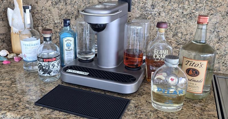 Bartesian machine on a granite countertop with six liquor bottles: Teremana, Espolon, Bombay Sapphire, Elijah Craig, Papa's Pilar and Tito's